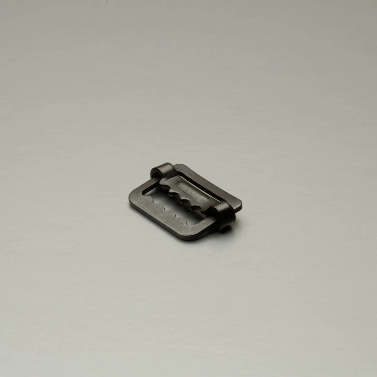 Pressed frame sliding bar buckle